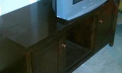 Beautiful dark brown tv stand with two side doors for storage. 30.00 --