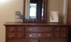Good quality oak bedroom set, one low dresser with mirror, nightstand, and bed with nice head and foot board! Dove tail joints, great color and more!