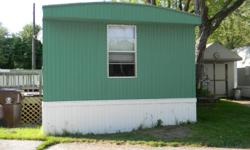 1991 Redman 2 bedroom 1 bath mobile home located in Pine Village Hobart, IN. Home in great shape. Brand new wood laminate flooring in kitchen and hallway. Master bath repainted and floored. Master bedroom repaneled and painted. Kitchen cabinets and walls