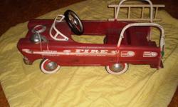 60's childs peddle fire engine with bell and one ladder. Condition is good, no rust, original tires, hubcaps has front visor, bell and one ladder. The steering wheel was replaced by someone else over 30 years ago. Children and grand children are too big.