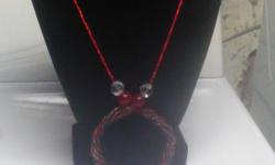 Beautifully hand crafted necklace with pendant. Includeds over 160+ glass beads along with the hand made multi strand pendant which includes three different colors. This necklace can finsh any red or brown outfit or whatever outffit you have.