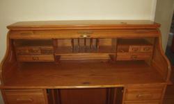 This is a great solid oak rolltop desk. We are selling some of our furniture that we no longer use anymore. This oak rolltop desk is made by Sure Wood. This would definitely make a wonderful addition to your home.