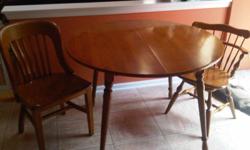 Hard Maple table with 2 charis. Chairs do not match each other but the wood color and style is a match. Comes with a leaf too. Nice condition and high quality