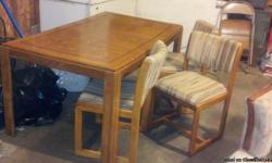 Wood table with 5 padded chairs. &nbsp;Chairs are in great shape. &nbsp;Table is bowed alittle in the center, but is still very sturdy.