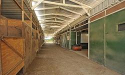Way to much to list. Two barns, 25 stalls plus loafing sheds, pastures, multiple storage inside and out,wash rack, all pipe fence, x-fence, huge arena, covered round pen, large stalls, tack storage for clients, office w/small bedrm in back, restroom,