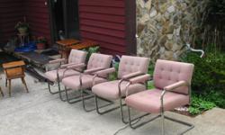 Frames are metal. Upholstered in a light mauve material. Good condition.
Would work well as extra rockers on a covered patio.