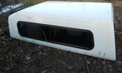 snug top camper shell in good shape white in color fits long bed tk 8' loacated in anchorage call are txt 244-3157 Robert