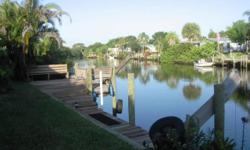 3 bedrooms, 2 bathrooms with large rooms, workshop, dock, rv/boat storage lot, screened in spa-pool, covered patio, lots of storage, big and bright kitchen with walk-in pantry. Located on canal to St. Lucie River with one fixed bridge. 1932 square feet