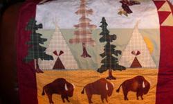 A western style wall hanging with Buffalo and tepees,