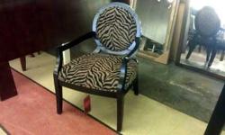 &nbsp;
The classic Louis style undergoes a dramatic makeover with a sleek black and tan zebra print. Subtle curves on the exposed wood arms and legs are bathed in a dark finish for an overall look that's exotic enough to spice up any space. Welt cord trim